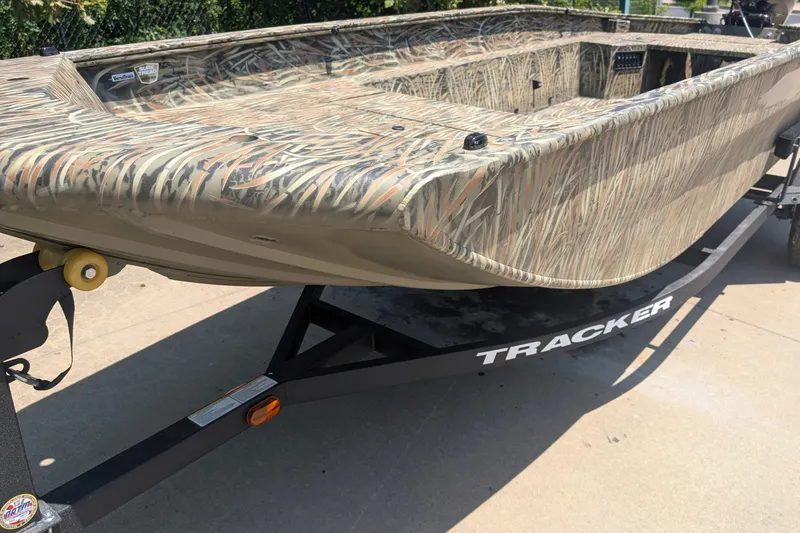 The Image of 2026 Tracker Grizzly 1650 T Prairie Wings Edition boat with camouflage design on trailer. - 0