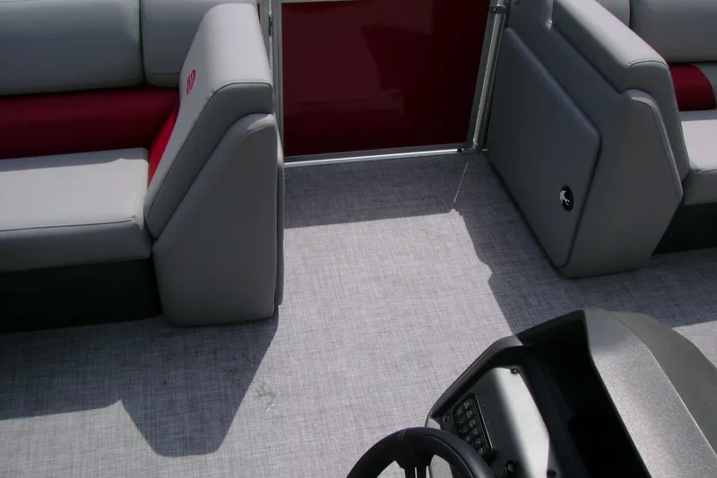 Slide: The Image of Interior of 2026 Sun Tracker Party Barge 20 DLX with gray seating and steering console. - 12