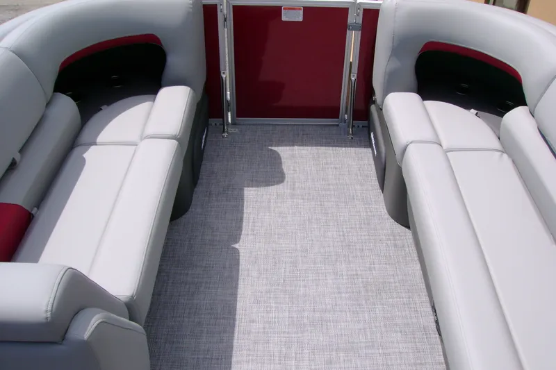 Slide: The Image of 2026 Sun Tracker Party Barge 20 DLX interior with gray seating and red accents. - 13