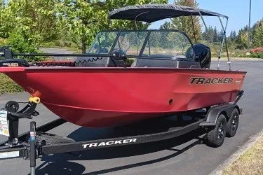 The Image of 2026 Tracker Pro Guide V-175 WT boat on trailer, red exterior, parked outdoors. - 0