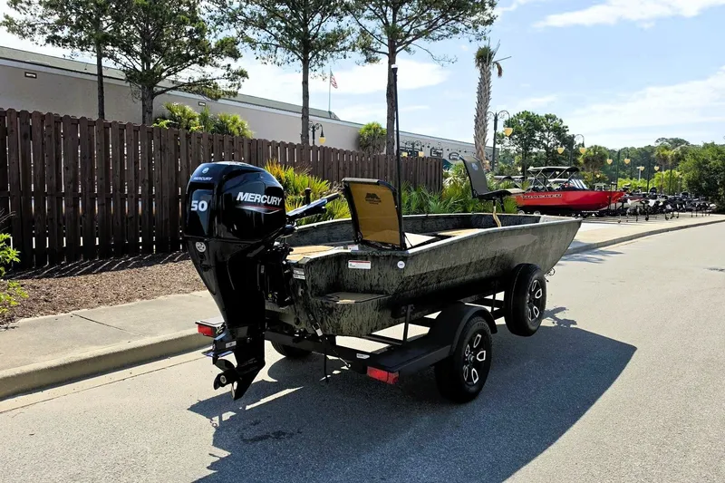 Slide: The Image of 2026 Tracker Grizzly 1650 T Prairie Wings Edition boat on trailer, parked outdoors. - 4