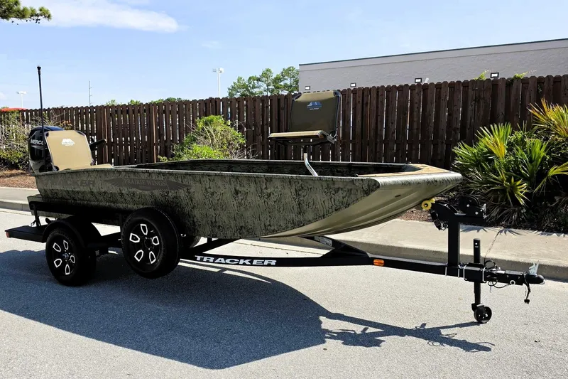 Slide: The Image of 2026 Tracker Grizzly 1650 T Prairie Wings Edition boat on trailer, parked outdoors. - 5