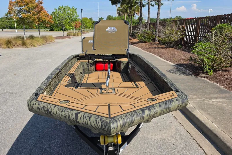 Slide: The Image of 2026 Tracker Grizzly 1650 T Prairie Wings Edition boat with camouflage design on a sunny day. - 11