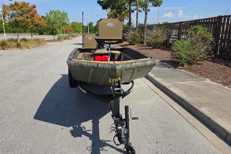 Slide: The Image of 2026 Tracker Grizzly 1650 T Prairie Wings Edition boat on trailer, parked outdoors. - 10