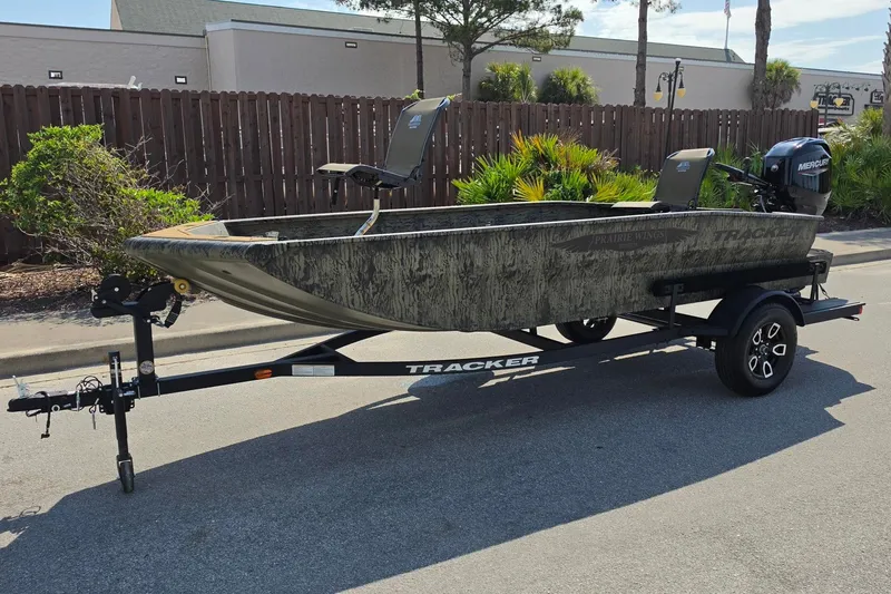 Slide: The Image of 2026 Tracker Grizzly 1650 T Prairie Wings Edition boat on trailer, parked outdoors. - 7