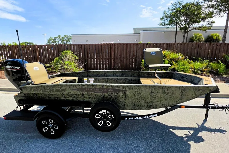 Slide: The Image of 2026 Tracker Grizzly 1650 T Prairie Wings Edition boat on trailer, outdoor setting. - 2