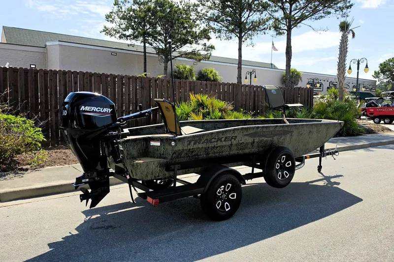 Slide: The Image of 2026 Tracker Grizzly 1650 T Prairie Wings Edition boat on trailer, parked outdoors. - 3