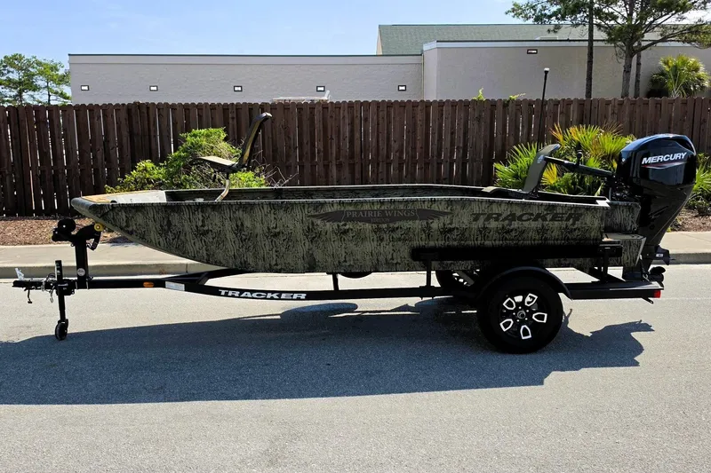 Slide: The Image of 2026 Tracker Grizzly 1650 T Prairie Wings Edition boat on trailer, side view. - 6