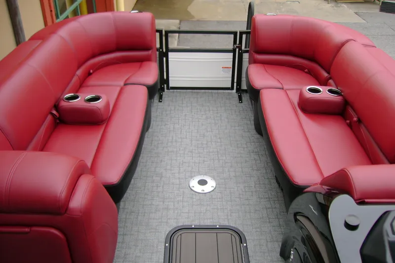 Slide: The Image of Luxurious red seating on 2026 Regency 230 DL boat interior with cup holders. - 13