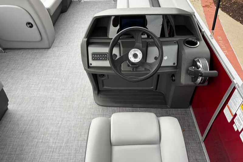 Slide: The Image of 2026 Sun Tracker Party Barge 18 DLX helm with steering wheel and controls. - 7