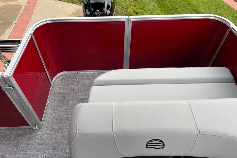 Slide: The Image of 2026 Sun Tracker Party Barge 18 DLX with red paneling and gray seating. - 6