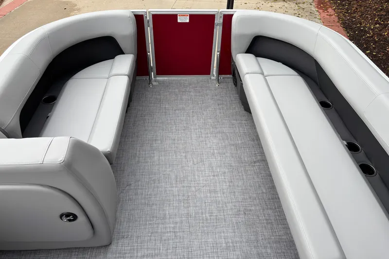 Slide: The Image of 2026 Sun Tracker Party Barge 18 DLX interior with gray seating and cup holders. - 4