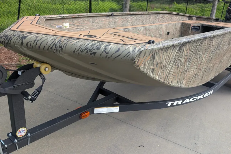 The Image of 2026 Tracker Grizzly 1650 T Prairie Wings Edition boat on trailer, camo design. - 0