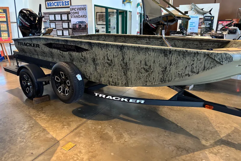 The Image of 2026 Tracker Grizzly 1650 T Prairie Wings Edition boat on display in showroom. - 0