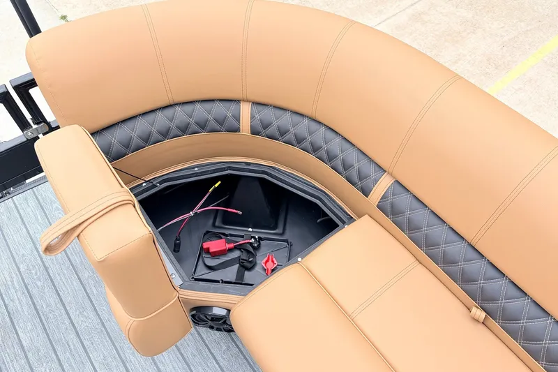 Slide: The Image of 2026 Ranger 223FC boat seat with storage compartment, featuring tan and black diamond-pattern upholstery. - 20