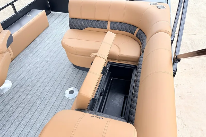 Slide: The Image of 2026 Ranger 223FC boat interior with tan leather seating and storage compartment. - 25
