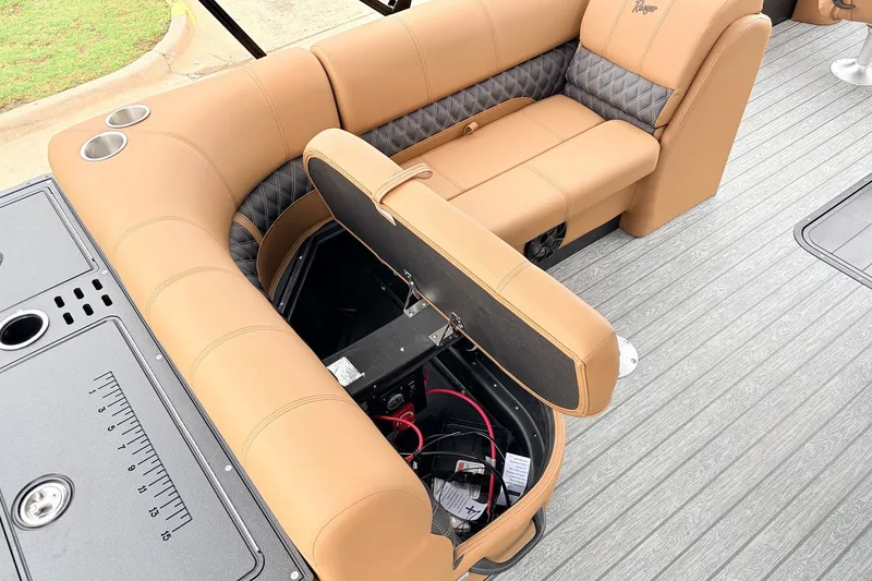 Slide: The Image of Luxurious 2026 Ranger 223FC boat interior with tan seating and storage compartment open. - 26