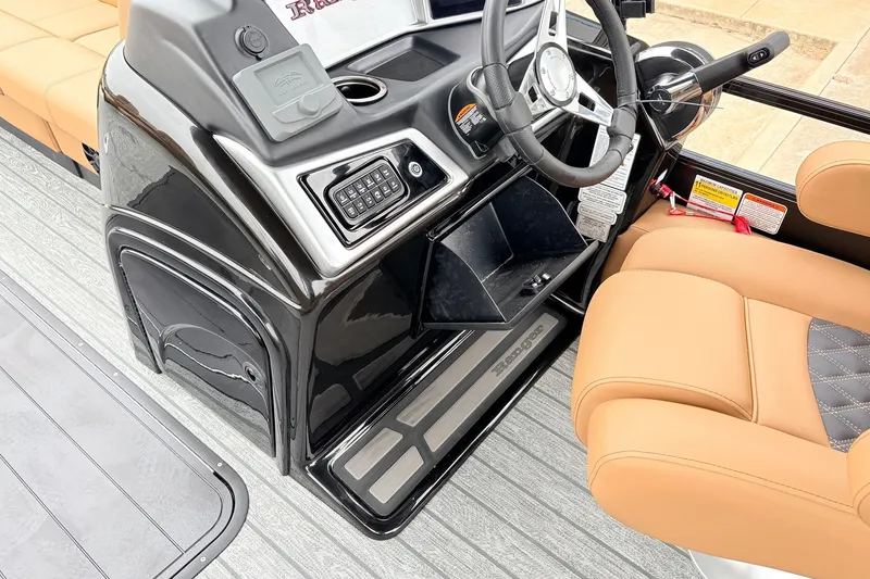 Slide: The Image of Interior of 2026 Ranger 223FC boat with steering wheel and tan seating. - 29