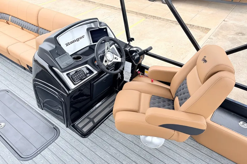 Slide: The Image of 2026 Ranger 223FC boat interior with tan seating and modern steering console. - 27