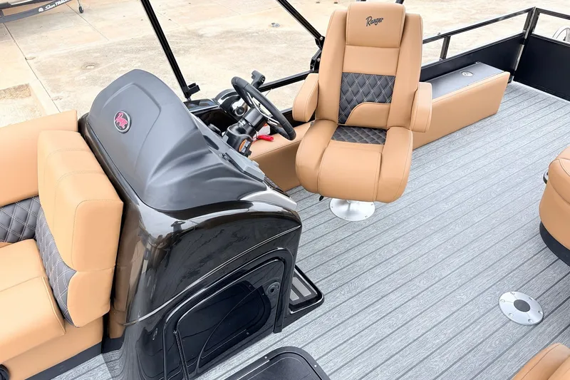 Slide: The Image of 2026 Ranger 223FC boat interior with tan and black seating, steering console, and modern design. - 33