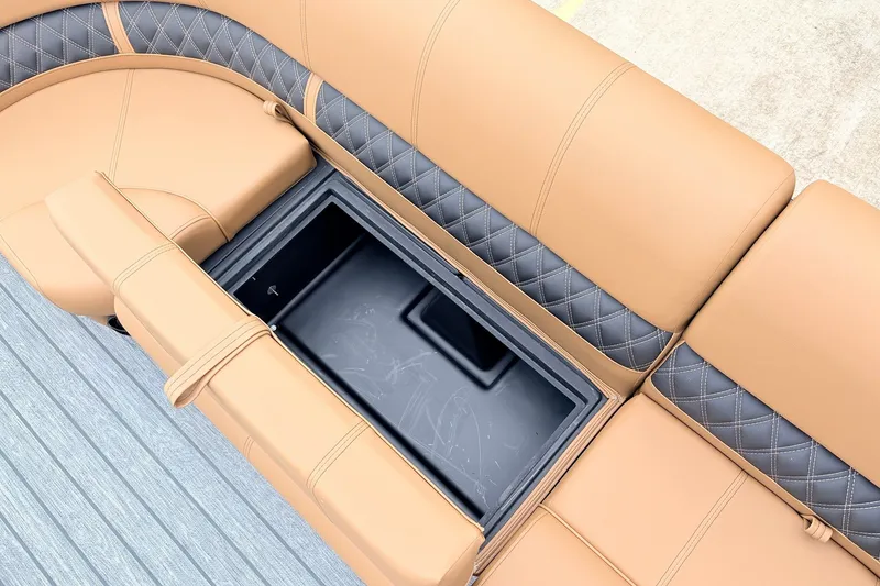 Slide: The Image of 2026 Ranger 223FC boat seating with storage compartment, featuring tan and black quilted upholstery. - 19