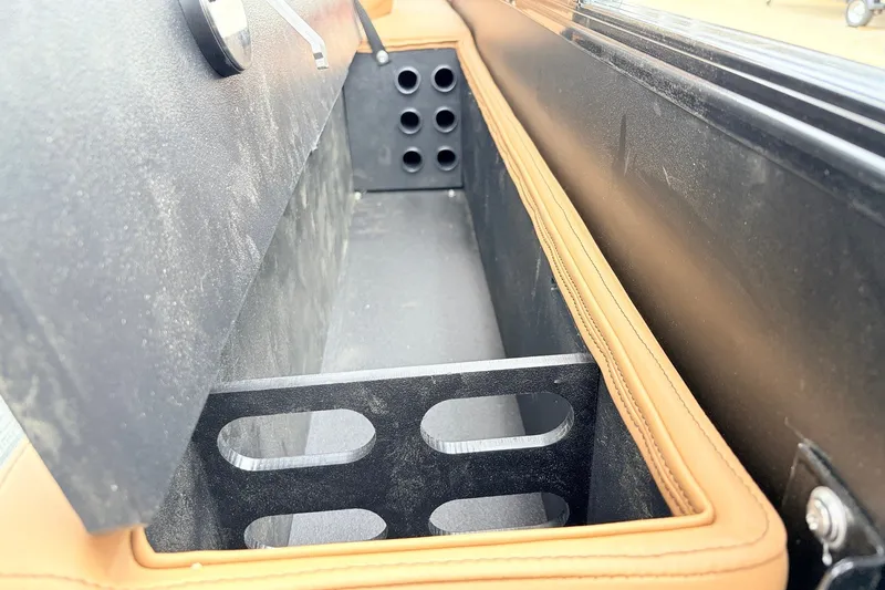 Slide: The Image of Open storage compartment in 2026 Ranger 223FC boat, featuring sleek design and leather trim. - 36