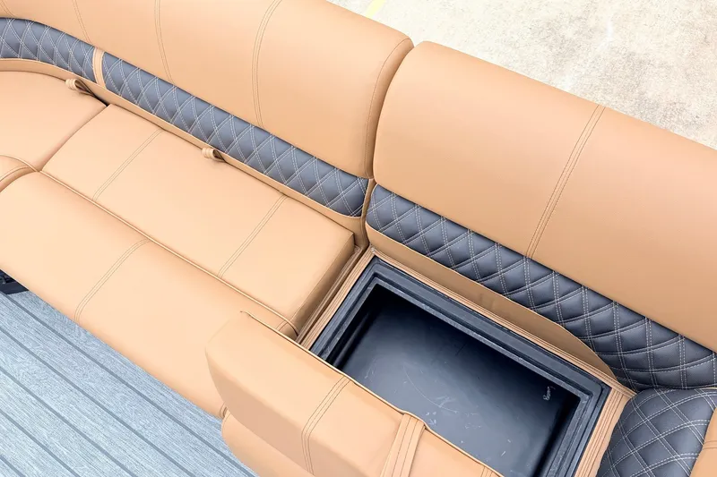 Slide: The Image of Luxurious tan and gray seating with storage compartment in 2026 Ranger 223FC boat. - 18
