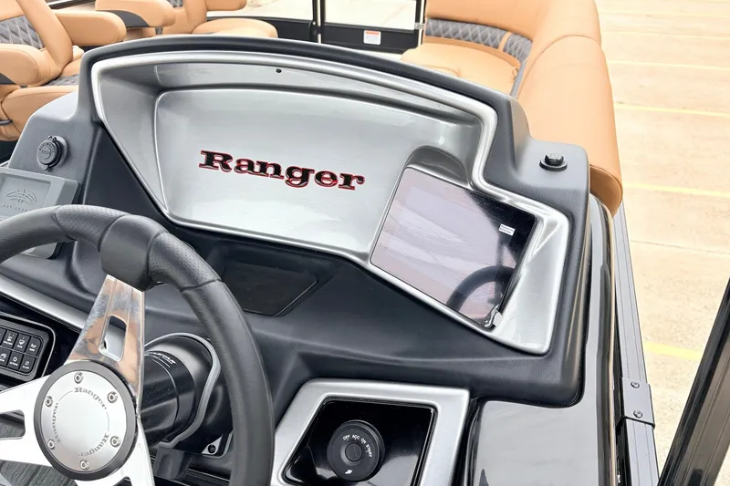 Slide: The Image of 2026 Ranger 223FC boat dashboard with steering wheel and control panel. - 32