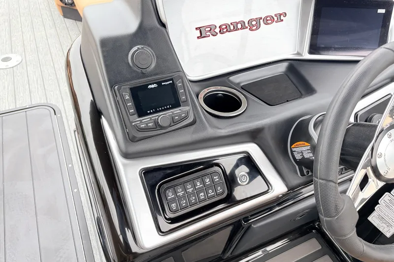 Slide: The Image of 2026 Ranger 223FC boat dashboard with control panel and steering wheel. - 31