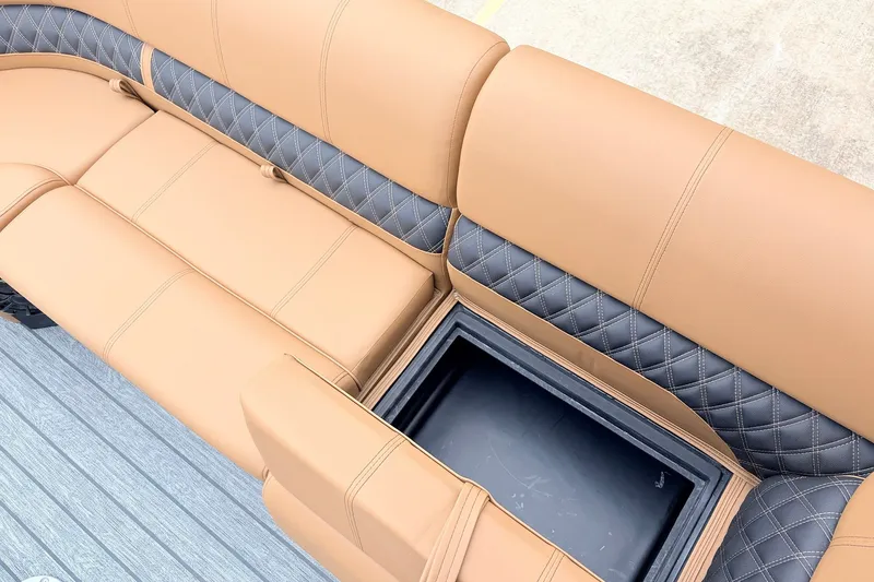 Slide: The Image of Luxurious seating with storage on 2026 Ranger 223FC boat, featuring tan and gray upholstery. - 17
