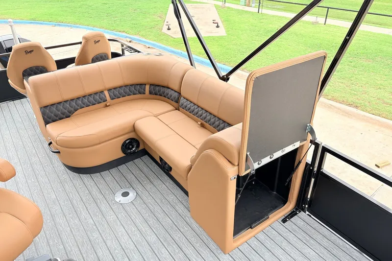 Slide: The Image of Luxurious seating on 2026 Ranger 223FC boat with tan upholstery and storage compartment. - 23