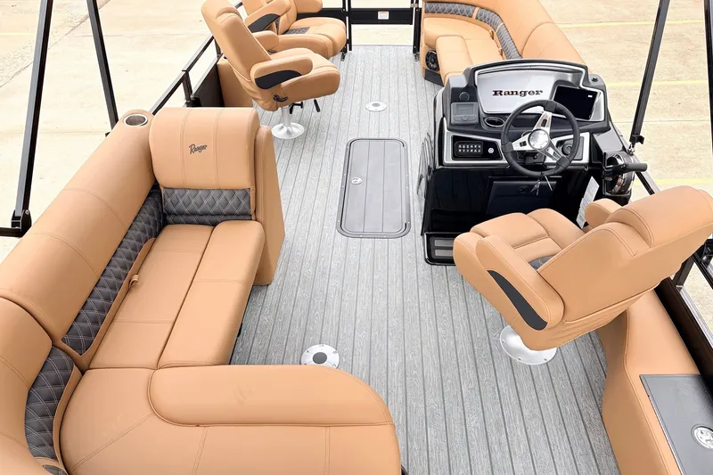 Slide: The Image of Luxurious 2026 Ranger 223FC boat interior with tan leather seating and modern steering console. - 11