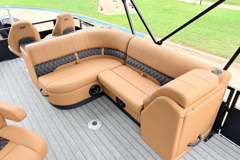 Slide: The Image of Luxurious tan seating on 2026 Ranger 223FC boat, featuring diamond-patterned accents and cup holders. - 22