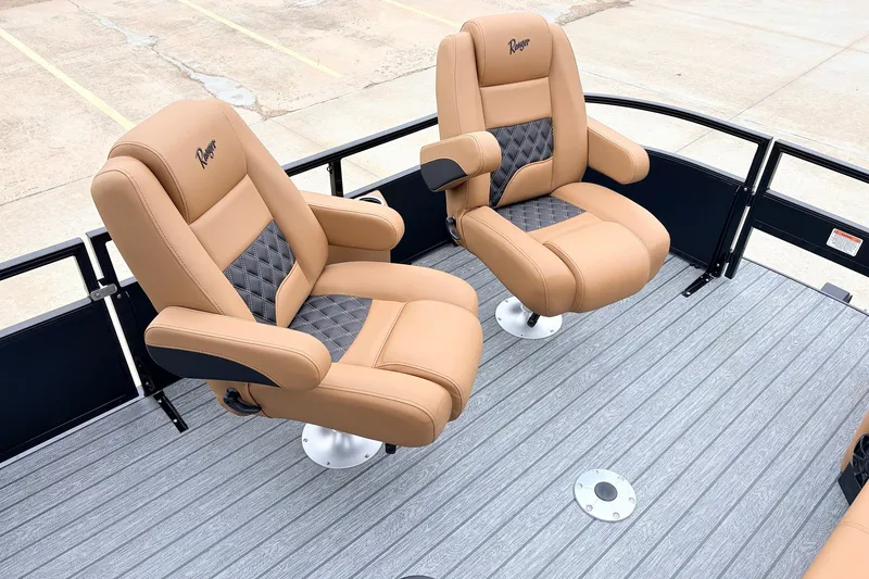 Slide: The Image of 2026 Ranger 223FC boat seats, tan leather with diamond-patterned inserts, on a gray deck. - 13