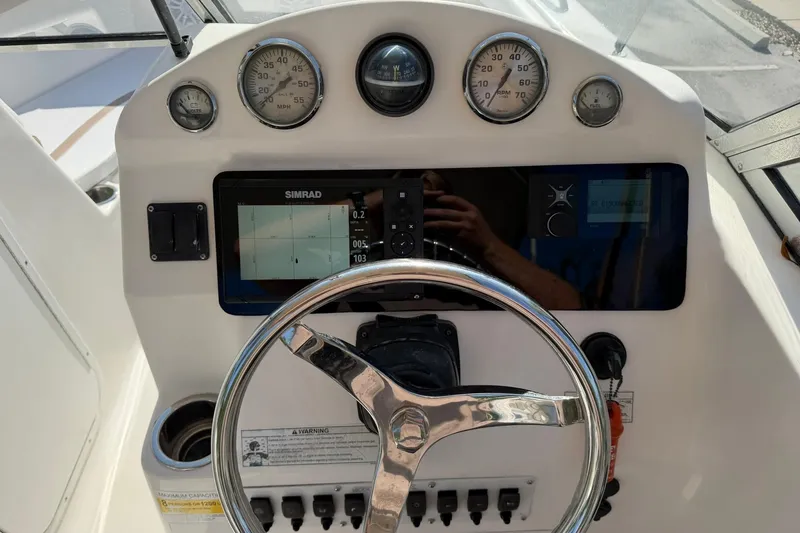 Slide: The Image of 2011 Sea Fox 216 Dual Console dashboard with steering wheel and navigation instruments. - 15
