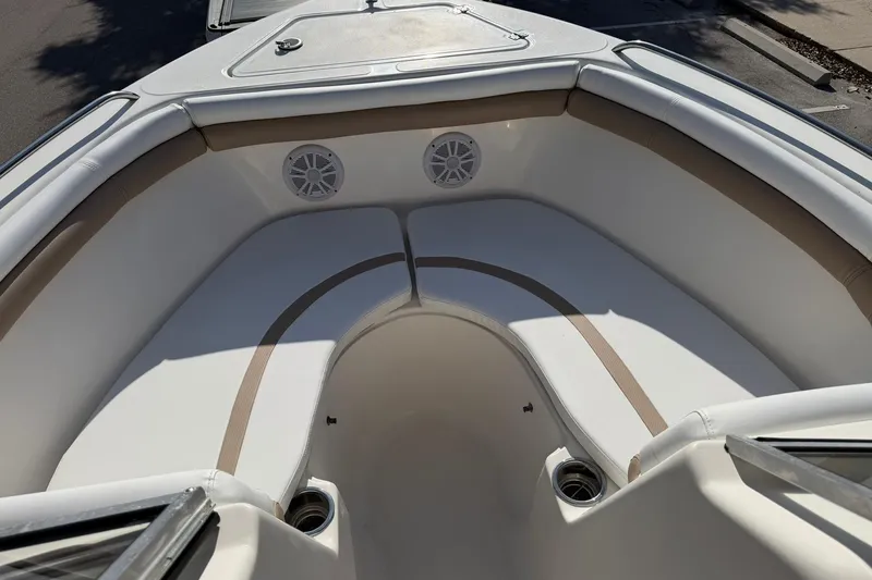 Slide: The Image of 2011 Sea Fox 216 Dual Console boat interior with cushioned seating and built-in speakers. - 16
