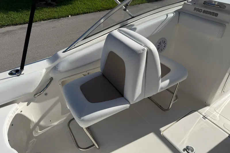 Slide: The Image of 2011 Sea Fox 216 Dual Console boat interior with white seating and stainless steel fixtures. - 12