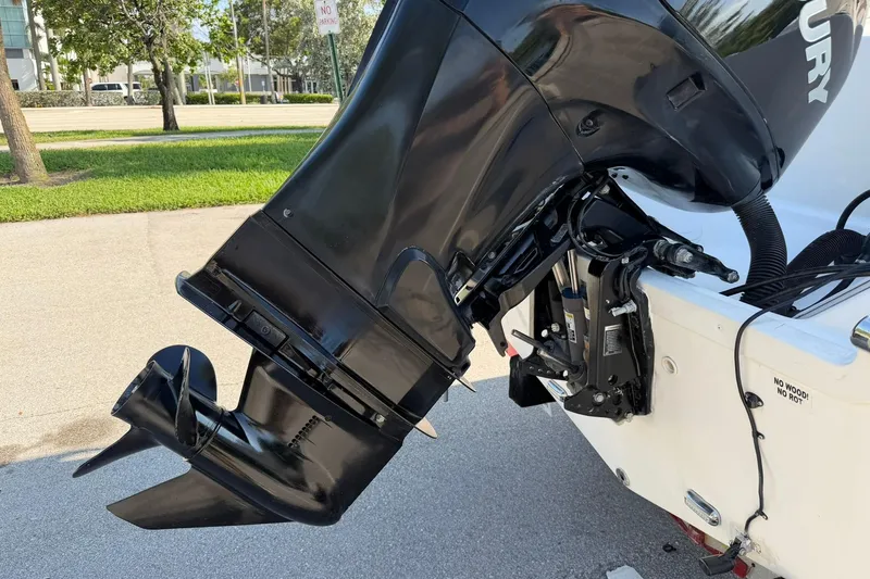 Slide: The Image of Outboard motor on a 2011 Sea Fox 216 Dual Console boat, parked on pavement. - 26