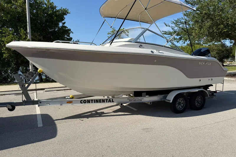 Slide: The Image of 2011 Sea Fox 216 Dual Console boat on a Continental trailer, parked outdoors. - 7