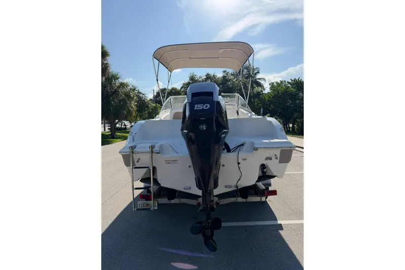 Slide: The Image of 2011 Sea Fox 216 Dual Console boat with outboard motor, parked on a sunny day. - 4