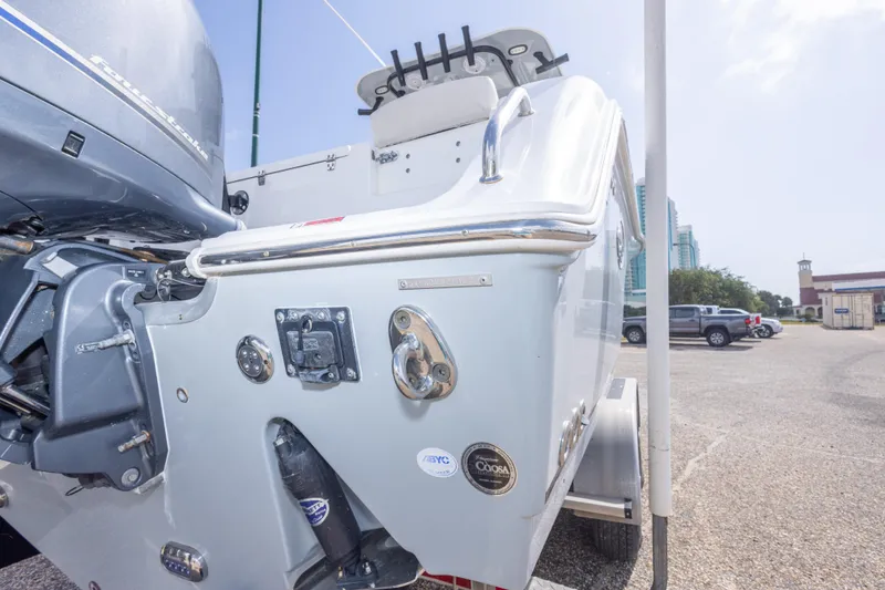 Slide: The Image of 2022 Sea Hunt Gamefish 27 boat rear view with motor and trailer. - 53