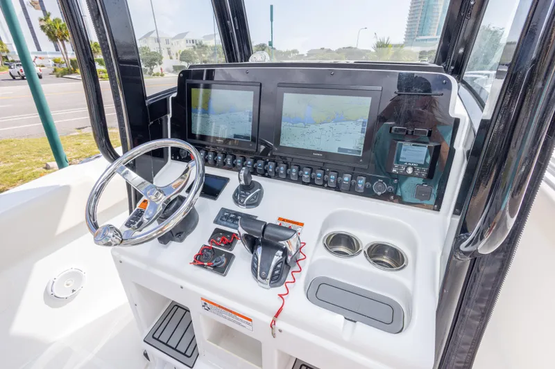 Slide: The Image of 2022 Sea Hunt Gamefish 27 helm with dual displays and controls. - 21