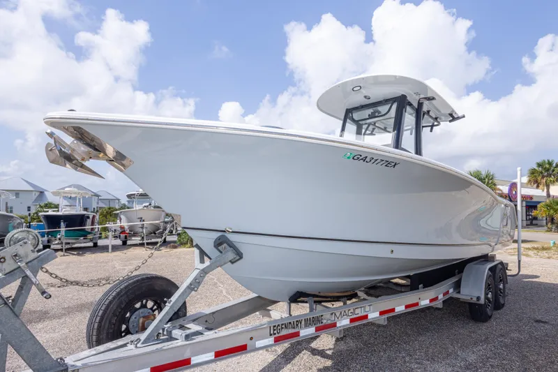 Slide: The Image of 2022 Sea Hunt Gamefish 27 boat on trailer under a cloudy sky. - 57