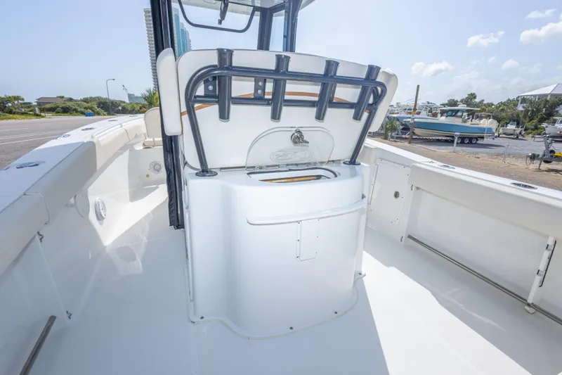 Slide: The Image of 2022 Sea Hunt Gamefish 27 boat interior with rod holders and storage compartment. - 38