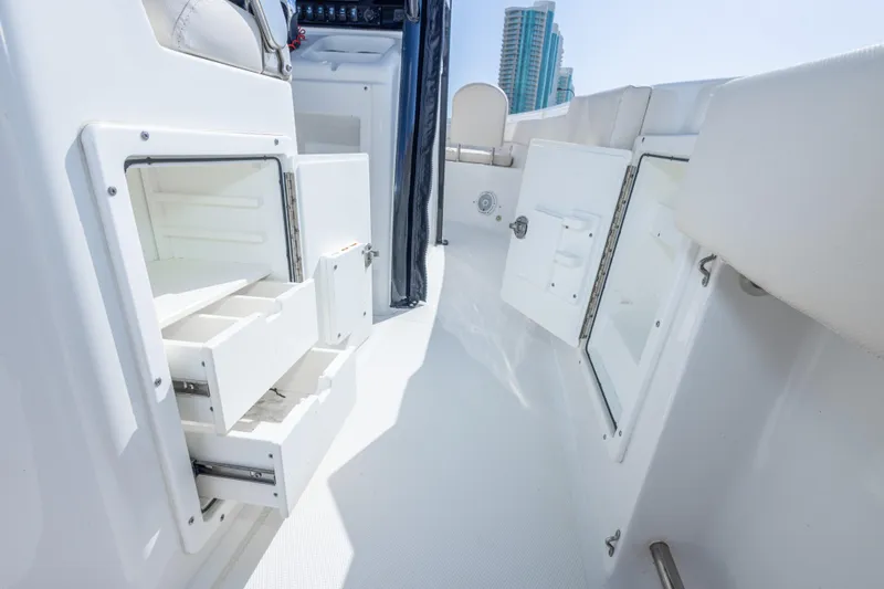 Slide: The Image of 2022 Sea Hunt Gamefish 27 boat interior with open storage compartments and sleek design. - 42