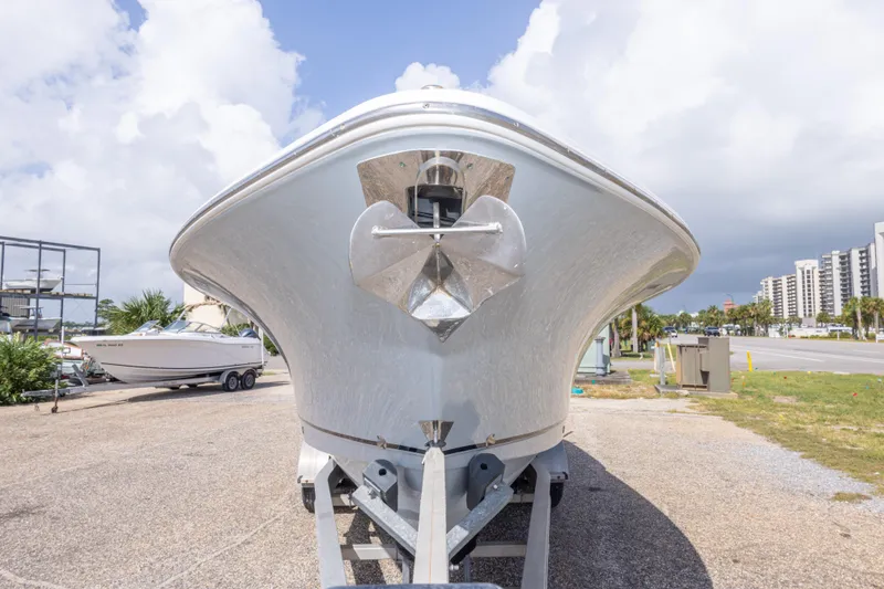 Slide: The Image of 2022 Sea Hunt Gamefish 27 boat on trailer, front view, under cloudy sky. - 12
