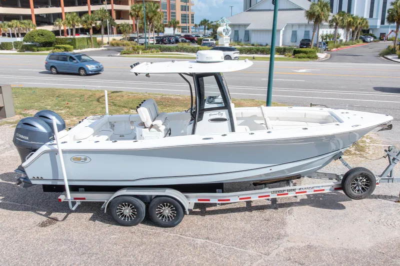 Slide: The Image of 2022 Sea Hunt Gamefish 27 boat on trailer, parked near a road. - 3