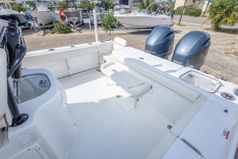 Slide: The Image of 2022 Sea Hunt Gamefish 27 boat interior with dual engines and seating area. - 37