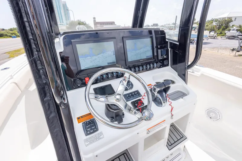 Slide: The Image of 2022 Sea Hunt Gamefish 27 helm with dual displays and steering wheel. - 20