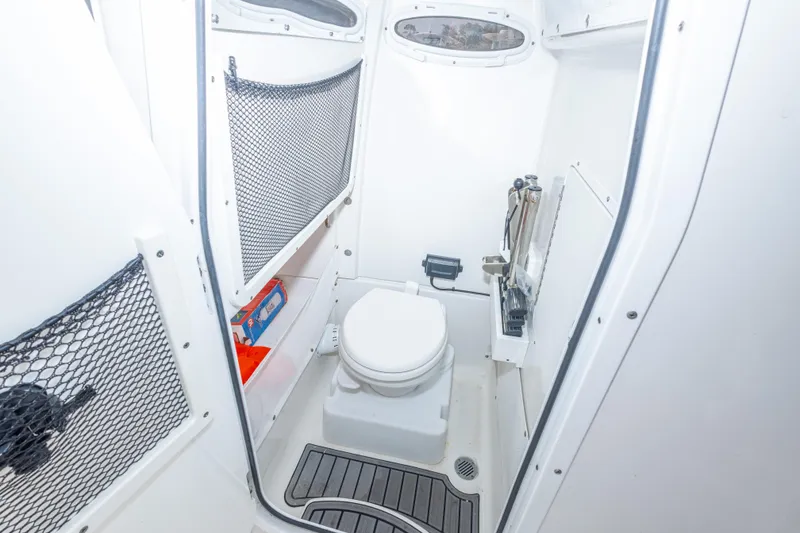 Slide: The Image of 2022 Sea Hunt Gamefish 27 boat interior with compact marine toilet. - 24